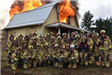 Large Group Posing in front of Burning Building