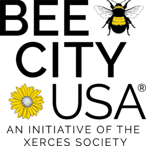 BeeCityUSA Logo, There is a Bee on a flower