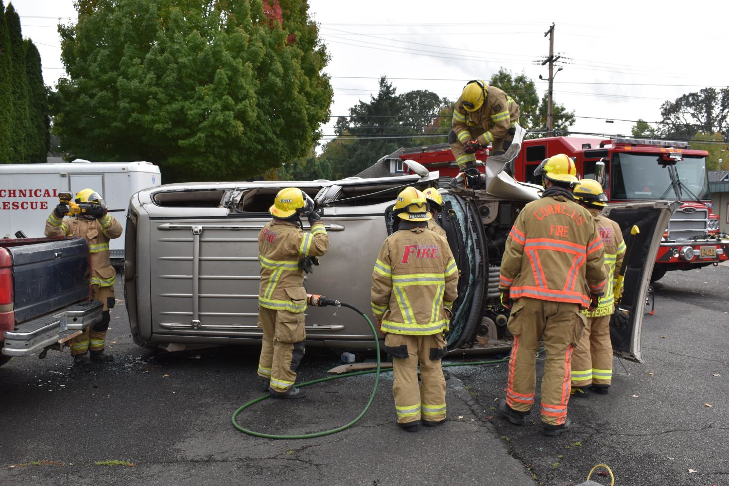 Firefighters by Flipped-Over Car