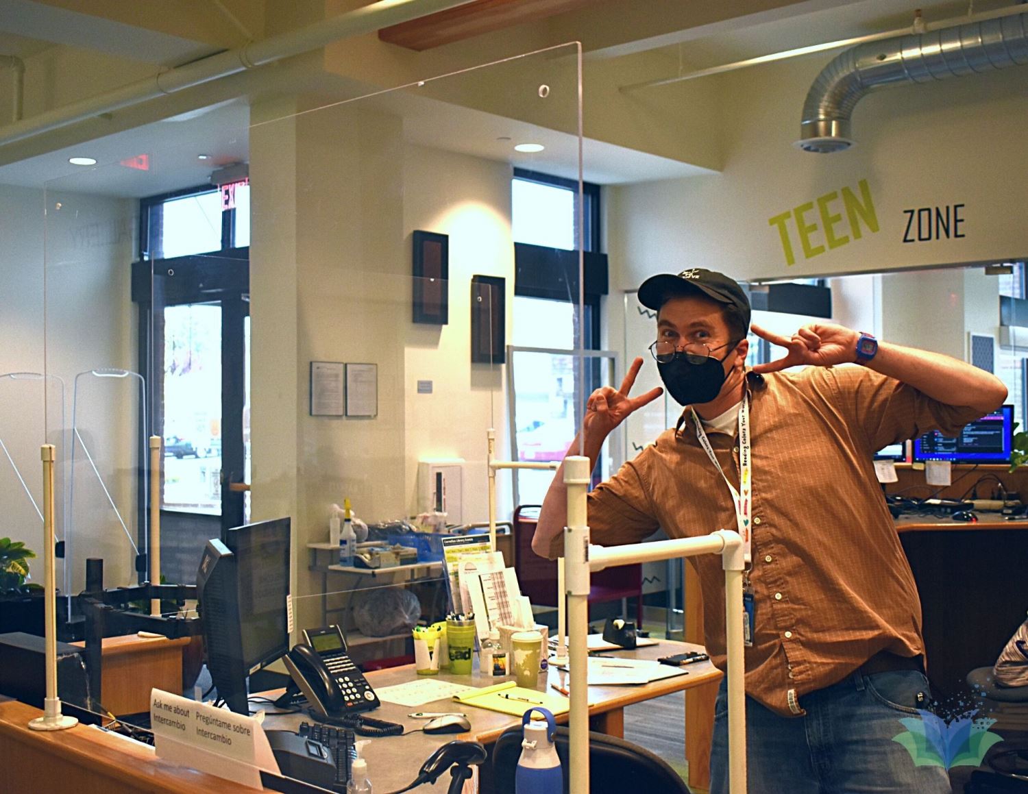 Staff member posing Goofily at Desk