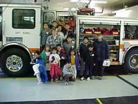 Children standing in front of a Fire Truck
